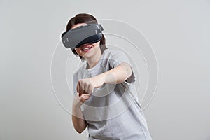 Happy young woman playing on VR glasses indoor, Virtual reality concept with young girl having fun with headset goggles