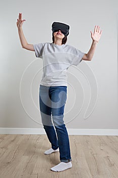 Happy young woman playing on VR glasses indoor, Virtual reality concept with young girl having fun with headset goggles