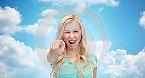 Happy young woman pointing finger to you