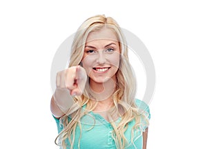 Happy young woman pointing finger to you