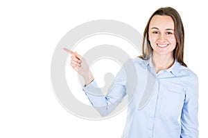 Happy young woman pointing side at copyspace