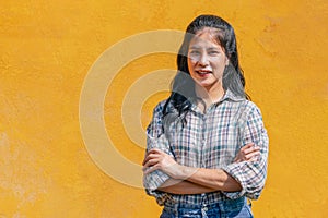 happy young woman posing isolated over yellow wall background