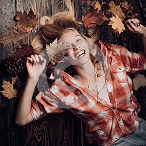 Happy young woman are preparing for autumn sunny day. Funny fac . Smile girl lies on wooden background and dreams of