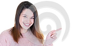 Happy young woman presenting and pointing side copy space
