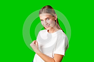 Happy Young Woman Raising Fists against green background