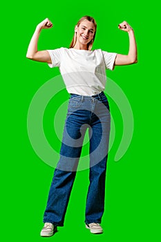 Happy Young Woman Raising Fists against green background photo
