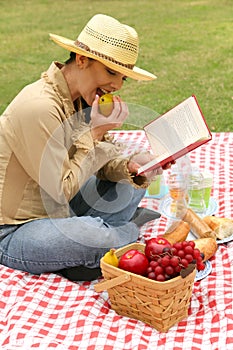 Happy Young Woman Reading Book Outdoor