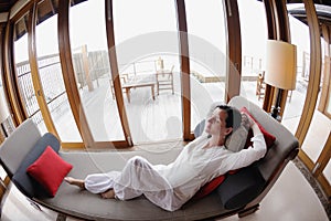 Happy young woman relax at home on sofa