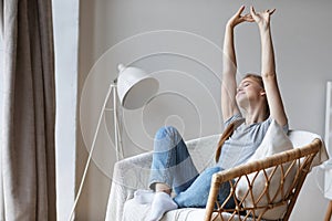 Happy young woman relaxing on comfortable chair