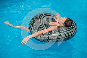 Happy young woman relaxing and enjoying summer in swimming pool