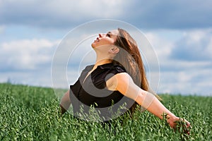 Happy young woman relaxing on nature
