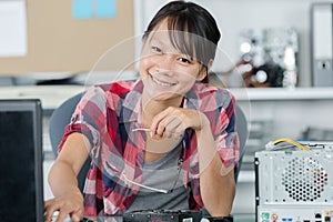 happy young woman repairing computer