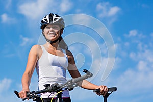 Happy Young Woman riding bicycle outside