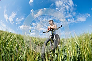 Happy Young Woman riding bicycle outside