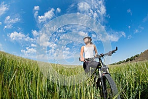 Happy Young Woman riding bicycle outside