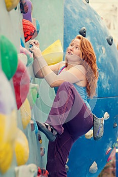 Happy Young Woman Rock Climbing. Colorful Fun Indoor Wall