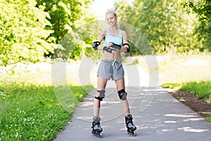 Happy young woman in rollerblades riding outdoors