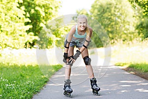 Happy young woman in rollerblades riding outdoors