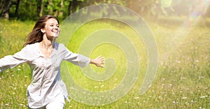 Happy Young Woman Enjoying Summer on the Green Meadow.