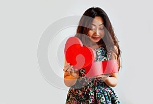 Happy young woman with shopping bag and tulips. isolated.