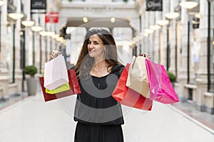 Happy young woman with shopping bags