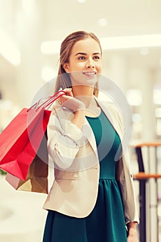 Happy young woman with shopping bags in mall