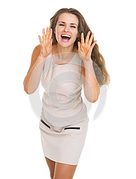 Happy young woman shouting through megaphone shaped hands