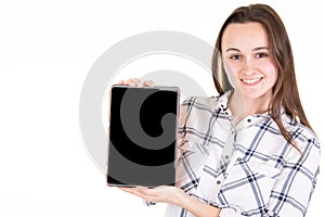 Happy young woman showing blank black empty tablet computer screen with copy space