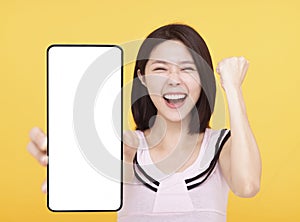 Happy Young woman  showing blank screen Smart phone In Her Hand