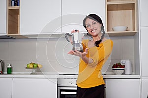 Happy Young woman showing moka pot