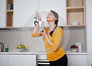 Happy Young woman showing moka pot