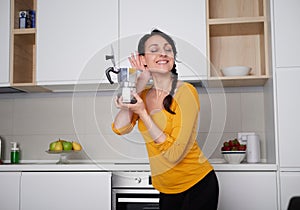 Happy Young woman showing moka pot