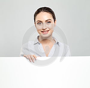 Happy young woman showing signboard with blank copyspace area for advertisiment or text message. Education and business concept