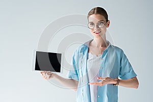 happy young woman showing tablet with blank screen