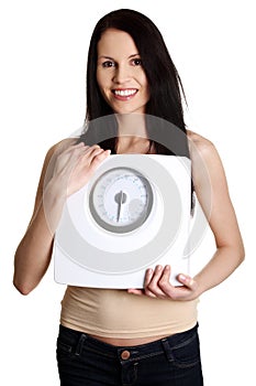 Happy young woman is showing weight.