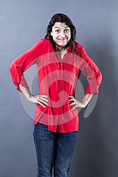 Happy young woman shrugging to express satisfaction