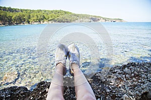 Happy young woman sitting, enjoy life on the beach at Sea.