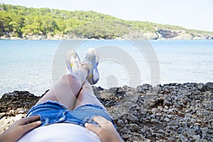 Happy young woman sitting, enjoy life on the beach at Sea.