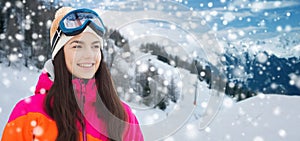 Happy young woman in ski goggles over mountains