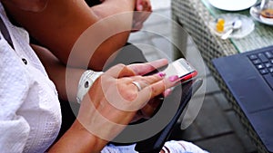 Happy young woman with smartphone in cafe