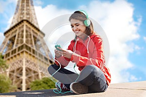Happy young woman with smartphone and headphones