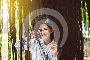 Happy young woman smiling face at public park in the morning,Positive thinking,Relax time