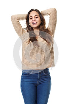 Happy young woman smiling with hands in hair