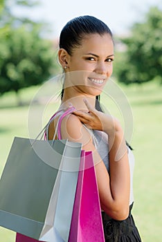 Happy young woman smiling with shopping bags