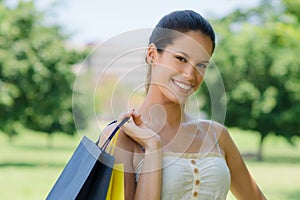 Happy young woman smiling with shopping bags