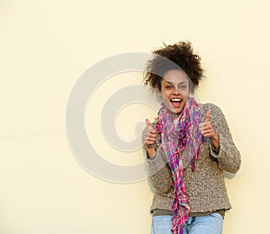 Happy young woman smiling with thumbs up sign