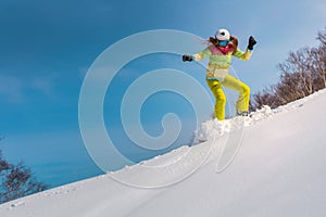 Happy young woman snowboard in deep snow