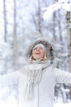 Happy young woman in in snowy forest