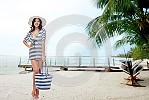 Happy young woman in summer clothes and sun hat