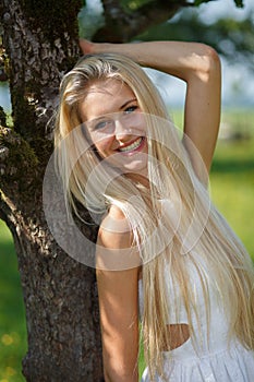 Happy young woman on a summer flower meadow outdoor